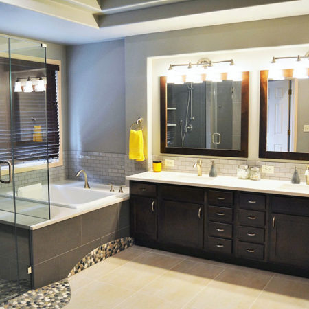 Completed bathroom new Japanese soaking tub quartz top tile surround custom double vanity new tile floor new tile pebbling shower