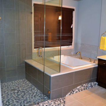 Completed shower Japanese soaking tub with new tile surround quartz top glass shower doors