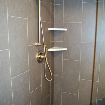 Completed shower new shower trim tile surround quartz corner shelves pebble flooring