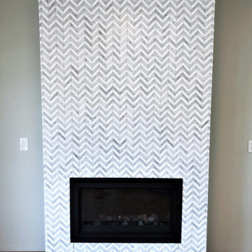 Completed fireplace with a new Heat n Glo fireplace and floor to ceiling tile
