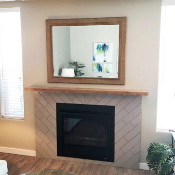 Completed fireplace with new gas fireplace insert, tile surround, and custom built mantel
