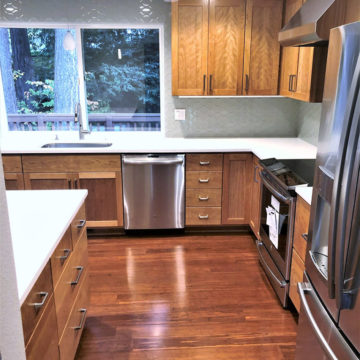 Custom built cabinets, new appliances, quartz counters, and tile backsplash