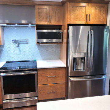 Custom cabinets, quartz counters, pot filler, tile backsplash, and new appliances