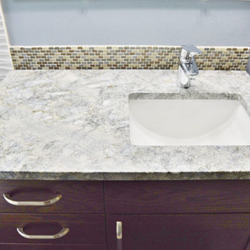 New bathroom vanity with quartz countertop and tile backsplash