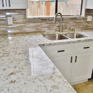 New cabinets quartz countertop and mosaic tile backsplash