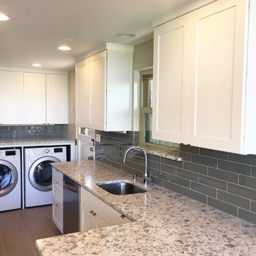 New cabinets quartz countertops tile backsplash and updated laundry area