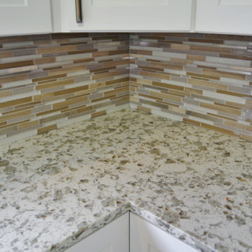 New quartz countertop and mosaic tile backsplash