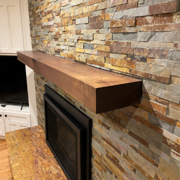 Completed fireplace remodel with new Heat n Glo insert stacked stone and custom rustic walnut mantel