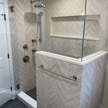 Custom shower with tile surround, frameless glass, and large shower wall niche