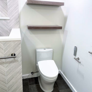 New Toto toilet with bidet seat and custom floating walnut shelves